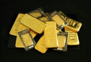 A collection of precious gold bars stacked elegantly, symbolizing wealth and prosperity.